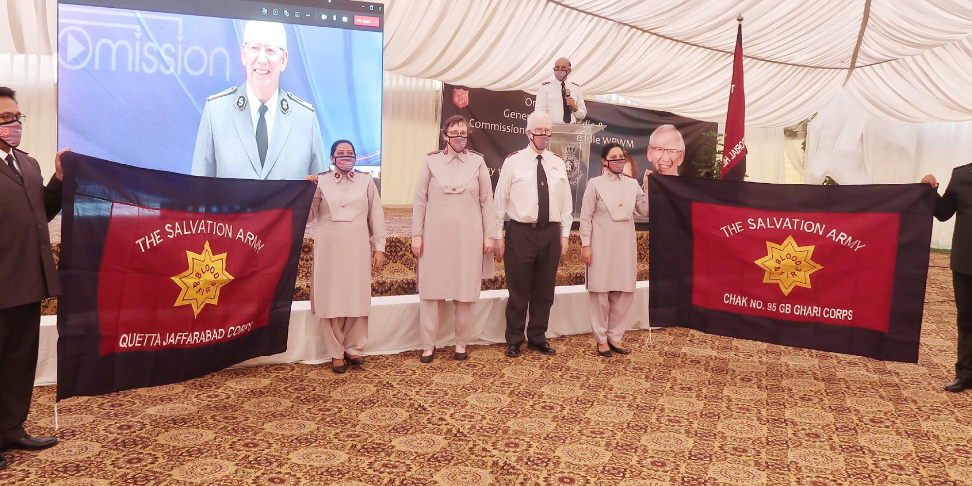Salvation Army officers holding flags