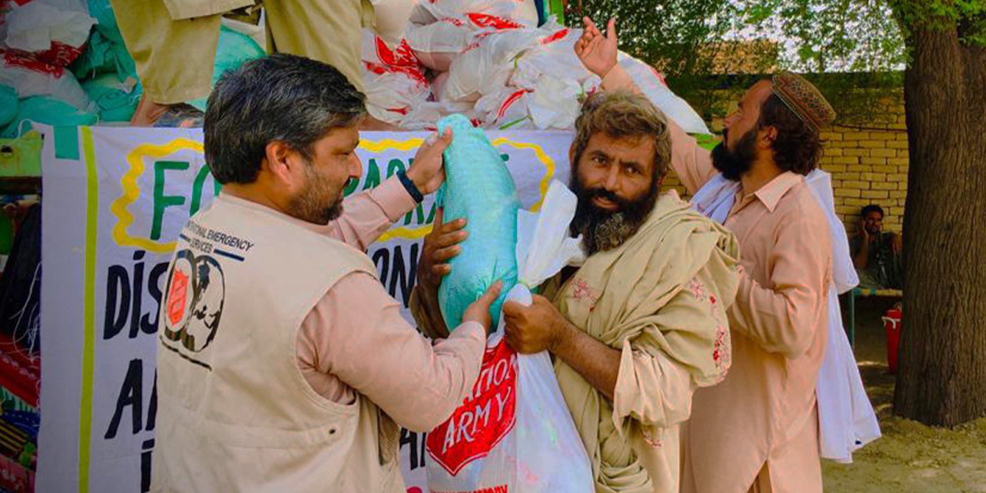 Volunteers unload supplies from a truck