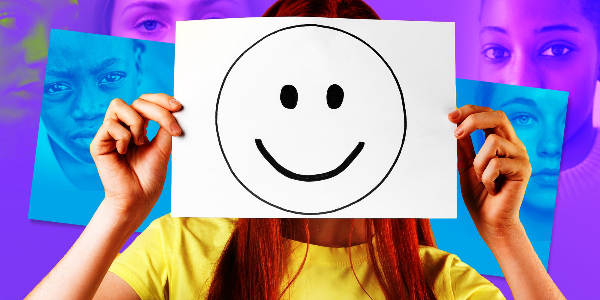 Young person holding up a smiley face