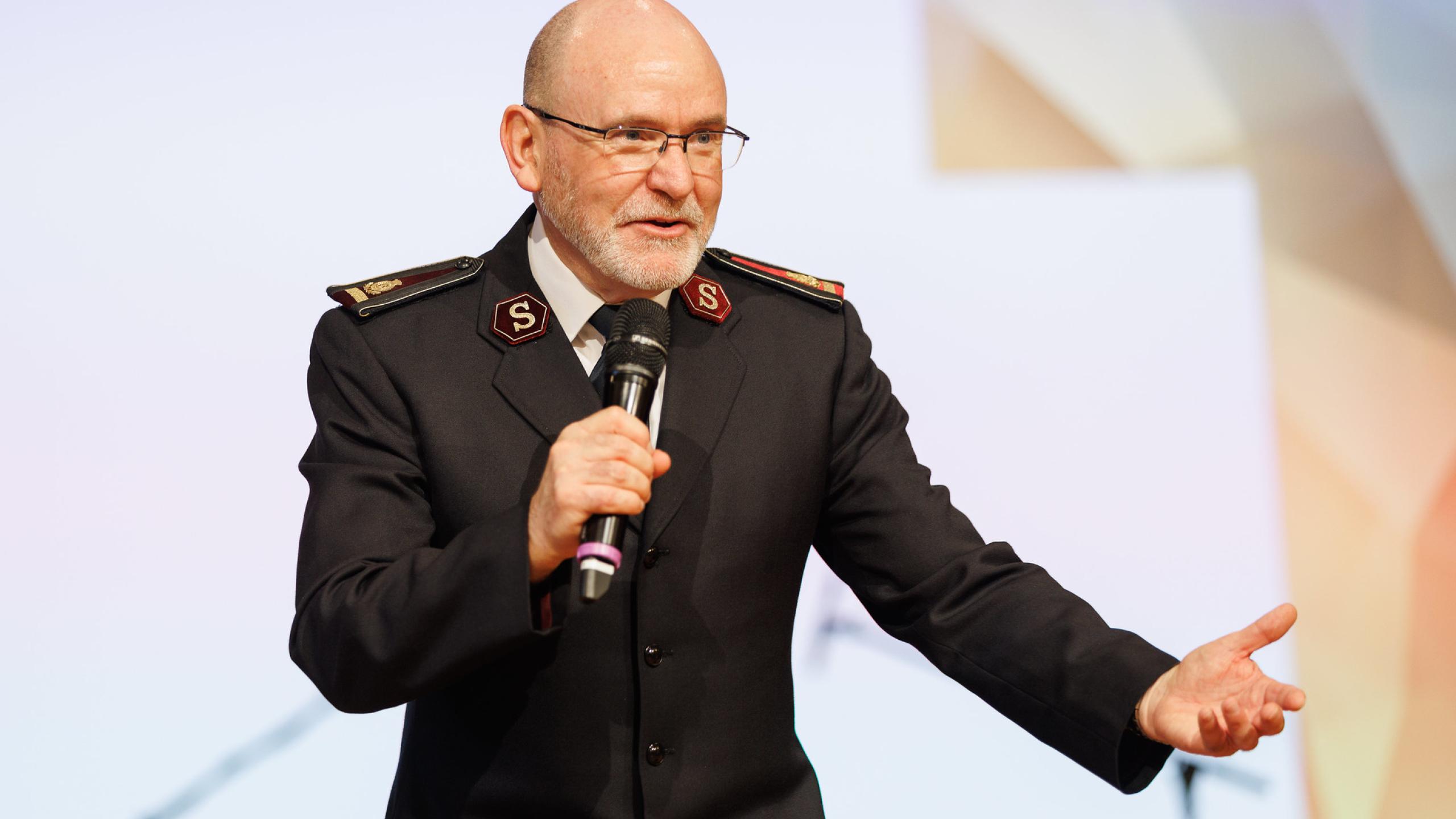 General Lyndon Buckingham, in full Salvation Army uniform, gives an address
