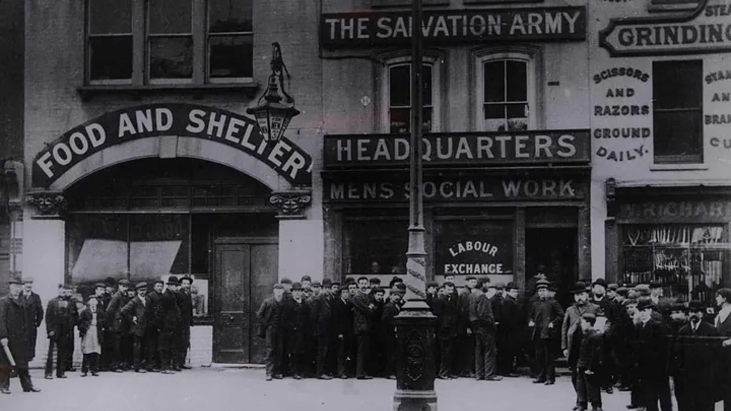 A crowd stands outside a Salvation Army building