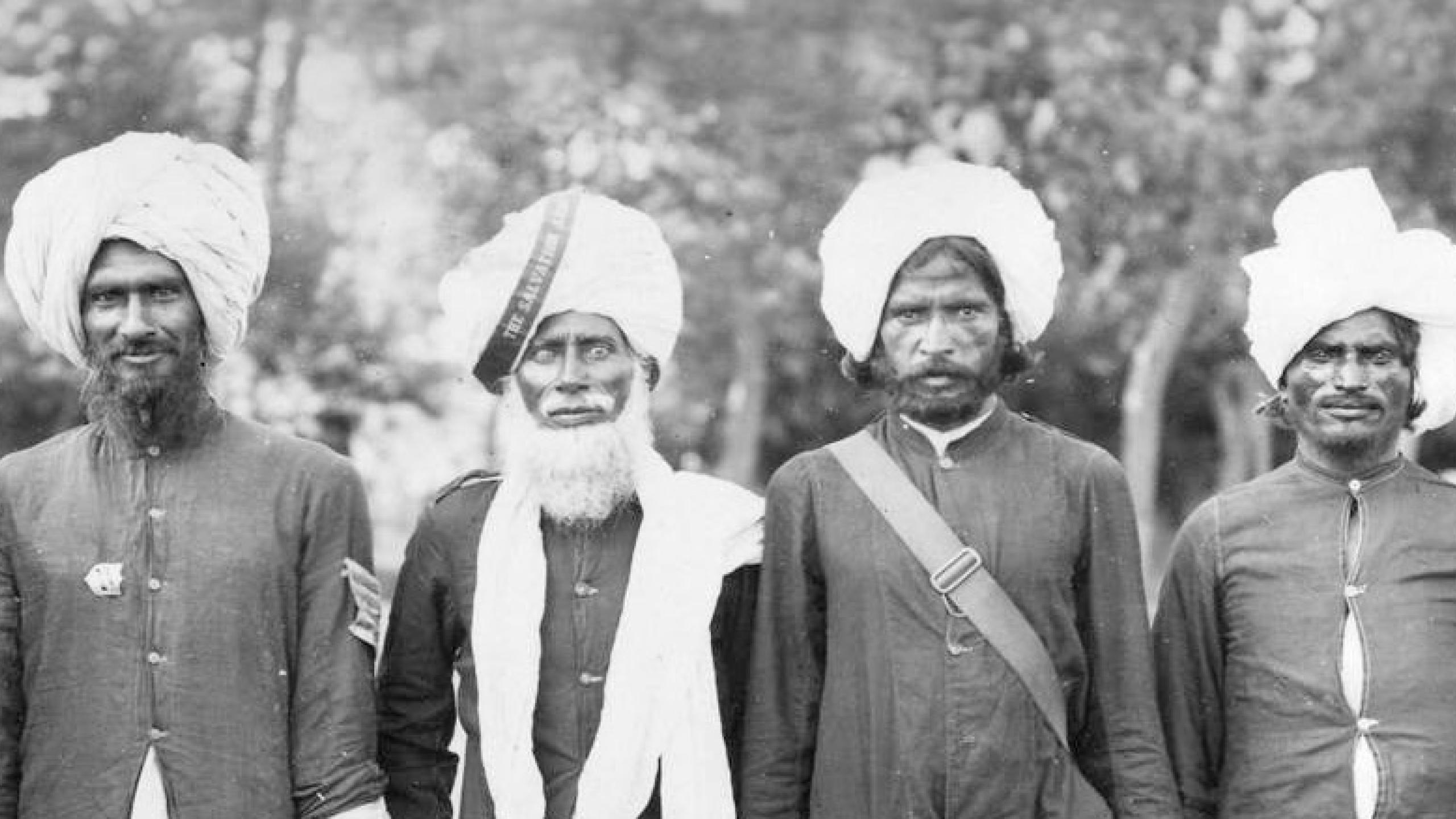 Six men in traditional Indian dress with Salvation Army badges and a ribbon