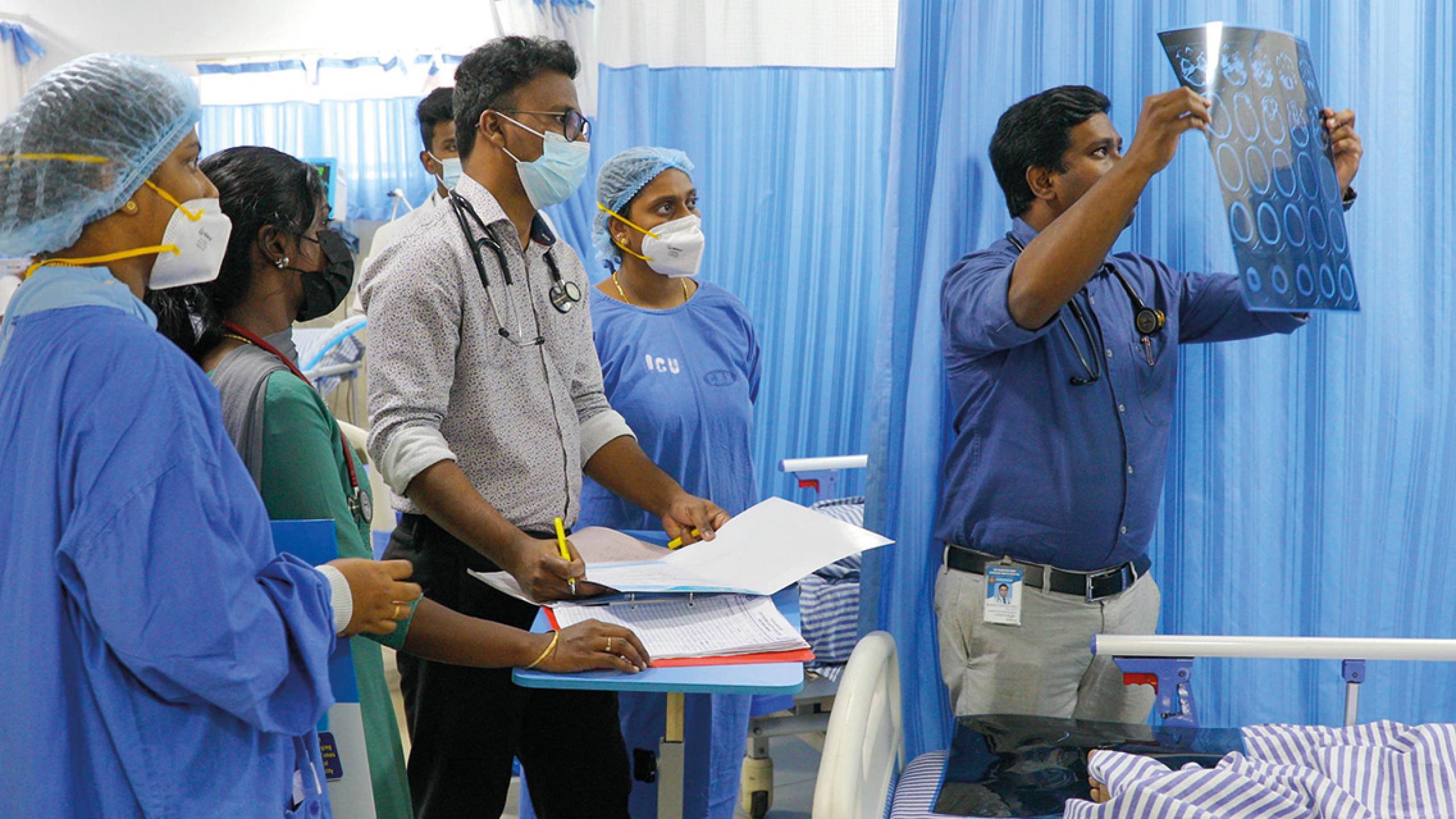 Doctors view test results at a Salvation Army hospital in India
