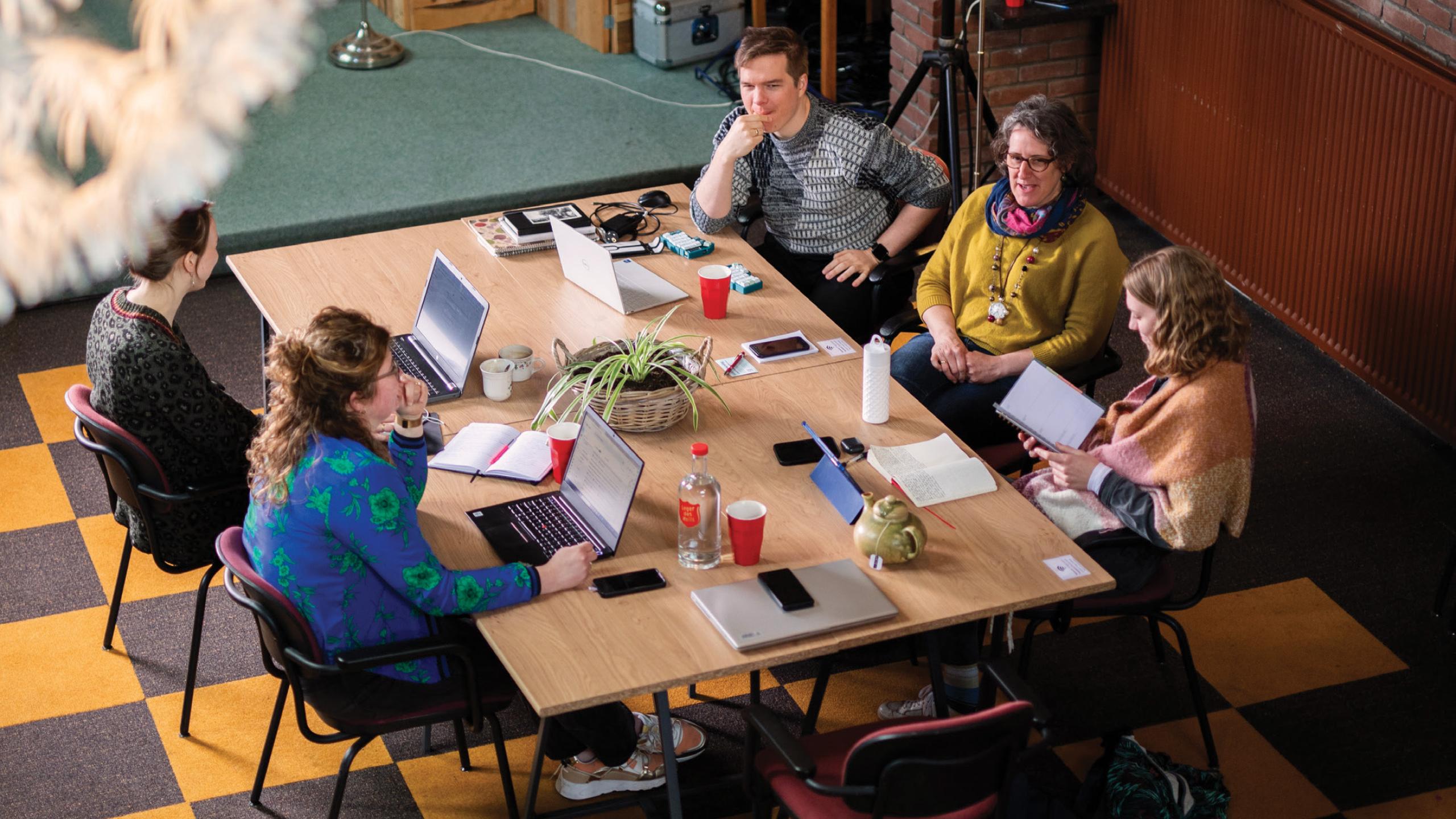 People sitting around a meeting room table