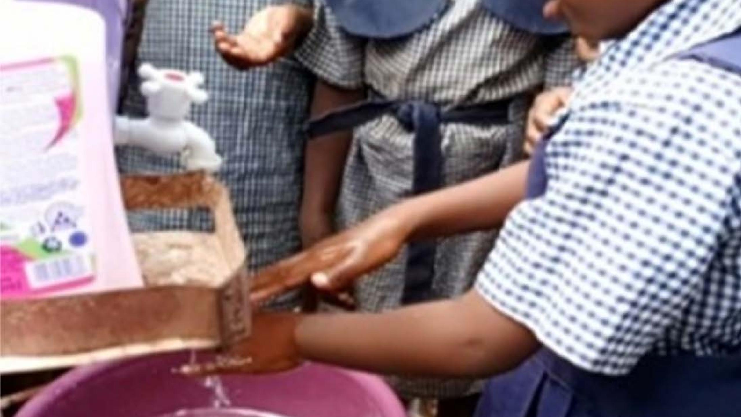 A child washes her hands