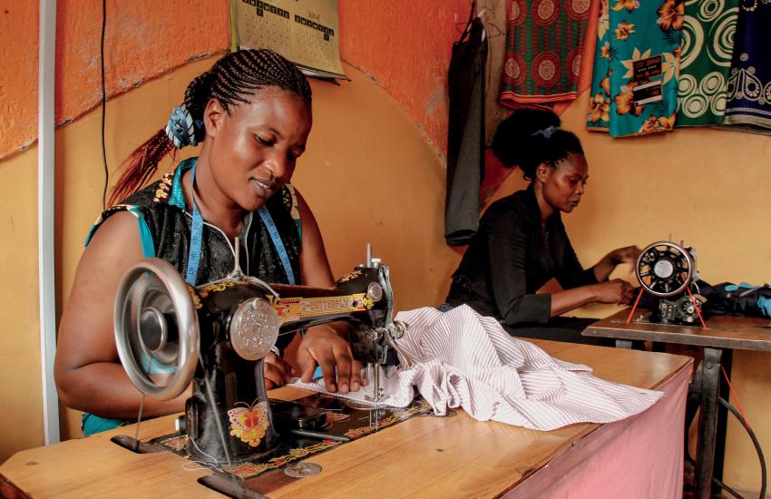 Two women work at sewing machines
