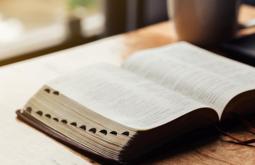 An open Bible sits on a table