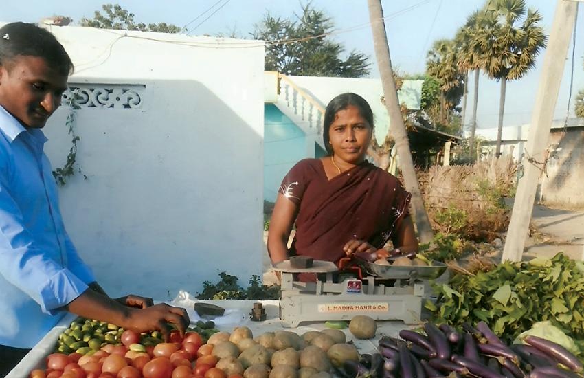 A woman runs a vegetable stall