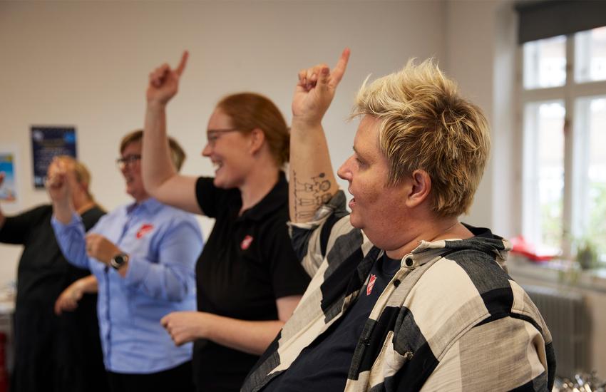 A group raise their hands in worship