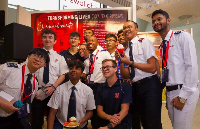 A group of the International Children and Young People Advisory group in front of the 160th exhibition 