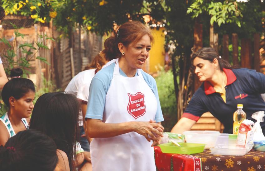 A woman in a Salvation Army apron leads a workshop