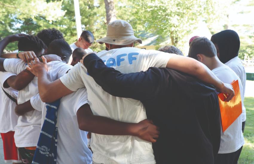 A group of young people with their arms around each other
