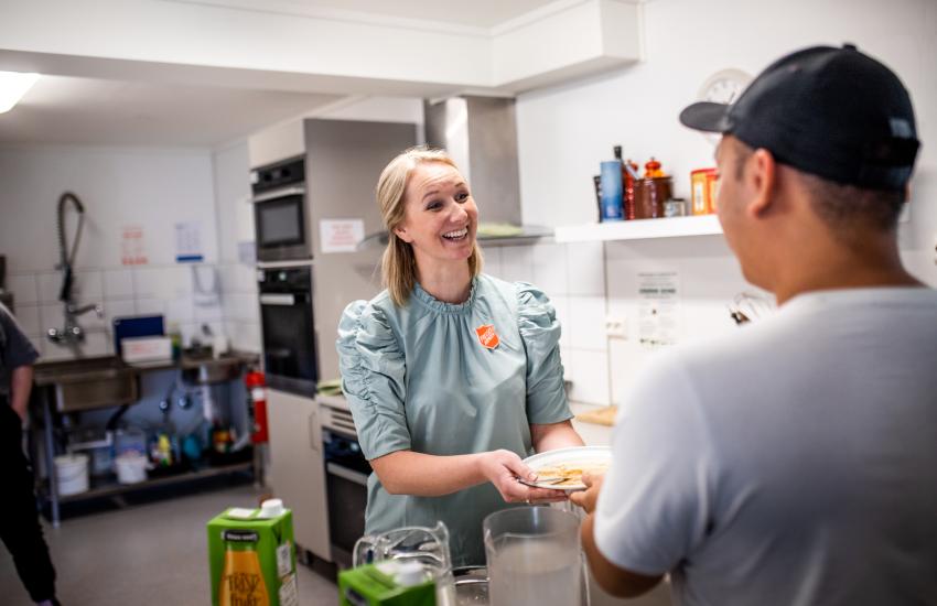 A volunteer offers a warm welcome