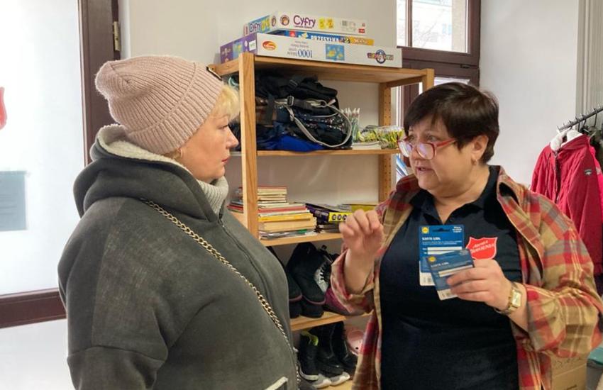 A Salvation Army team member distributing supermarket vouchers