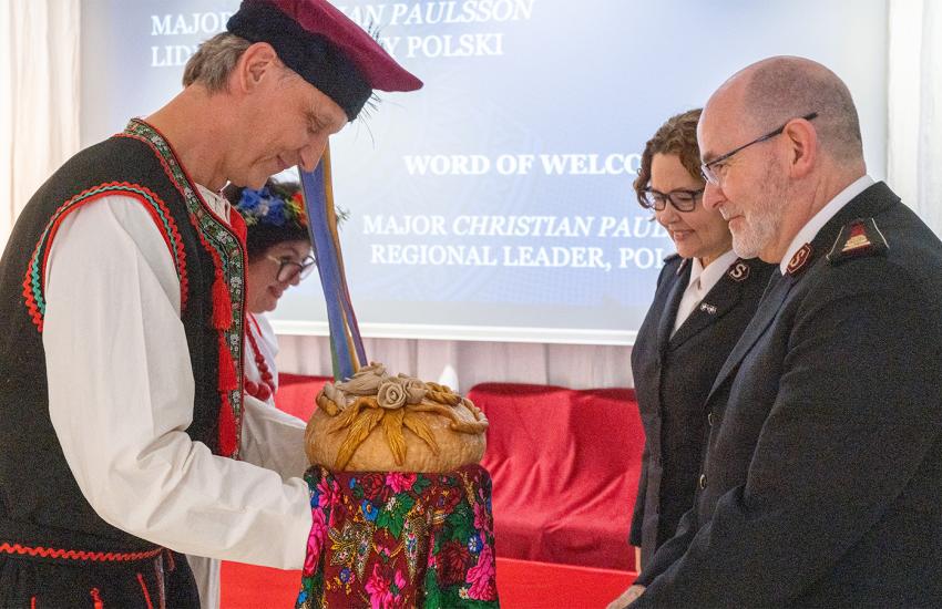 The international leaders are greeted with a traditional welcome gift of bread