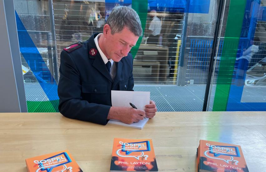 Major Phil Layton signs copies of Gospel Conversations