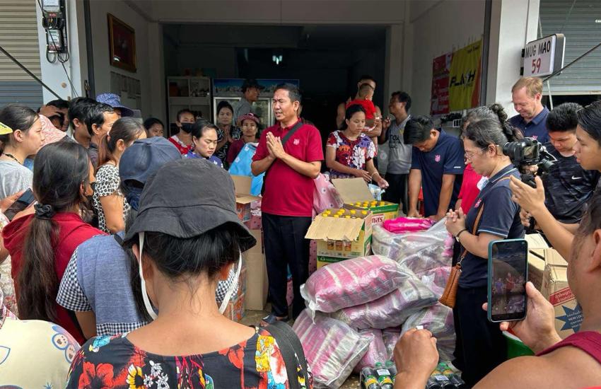 A Salvation Army team member prays over supplies