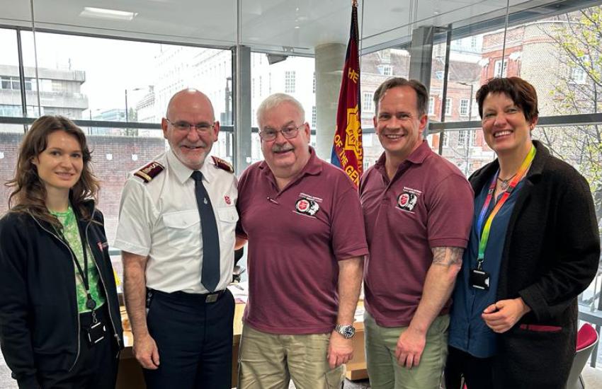 Major Brad Watson stands with General Lyndon Buckingham and members of the International Emergency Services team