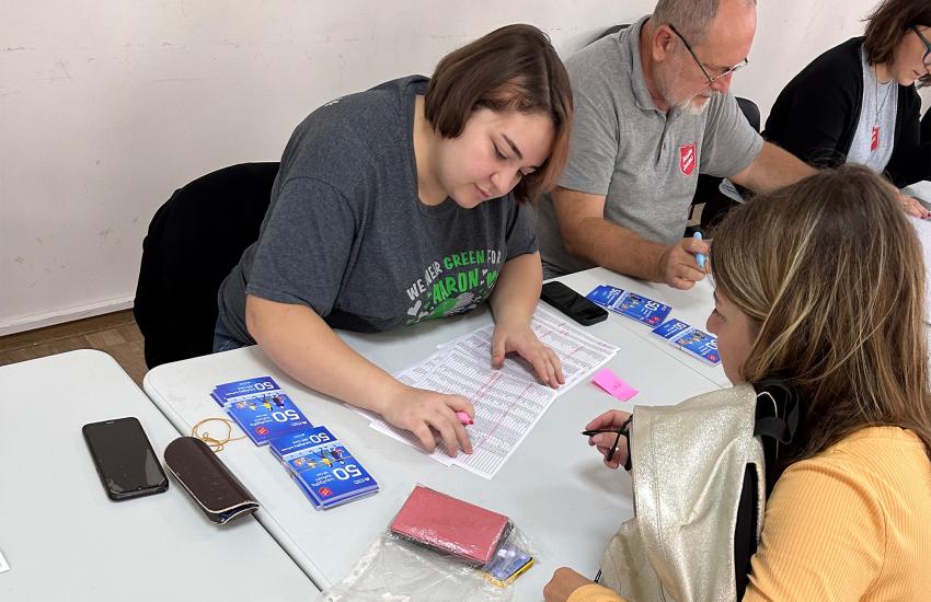 A Salvation Army team issue food vouchers for refugees