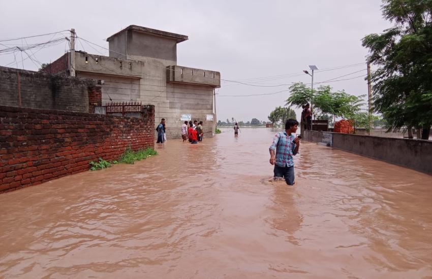 People wade through flood waters