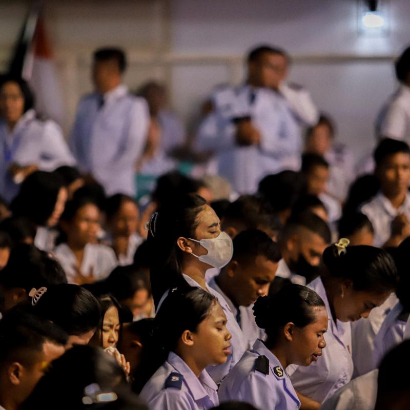 A group of Salvationists bow their heads in prayer