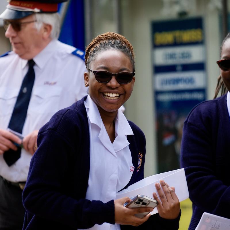 Women in Salvation Army uniform smile at the camera