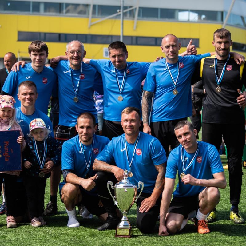 A football team with medals and Salvation Army shirts