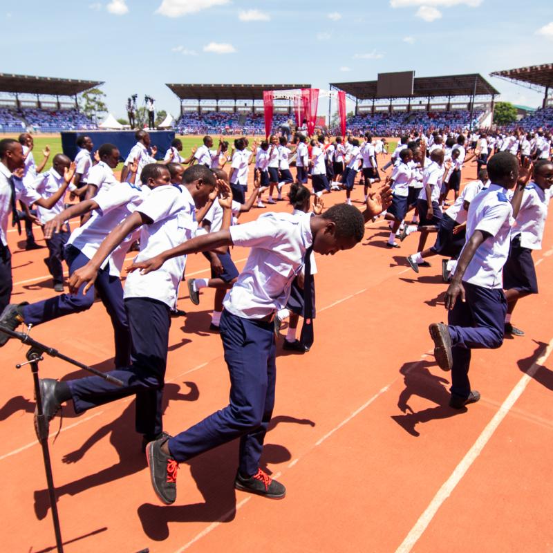 Young people dance in the middle of a stadium