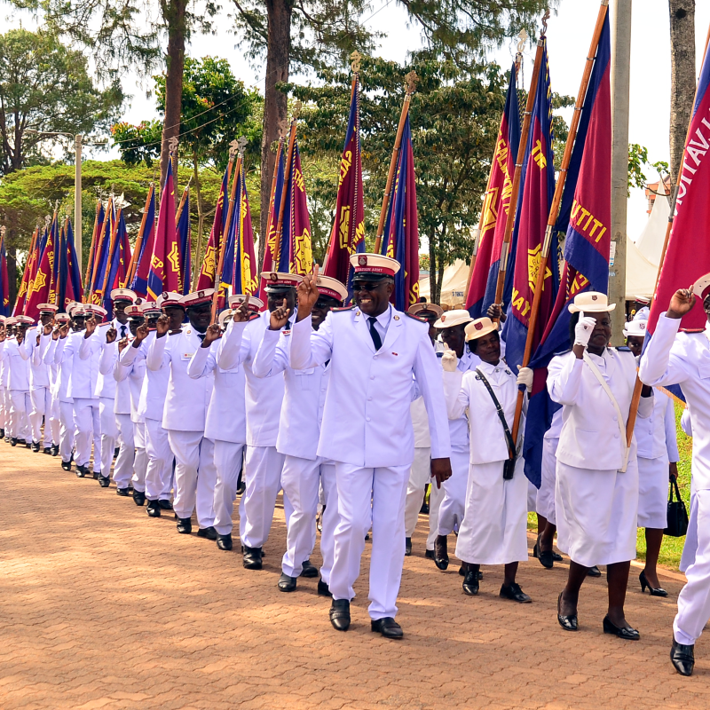 Men and women march holding Salvation Army flags