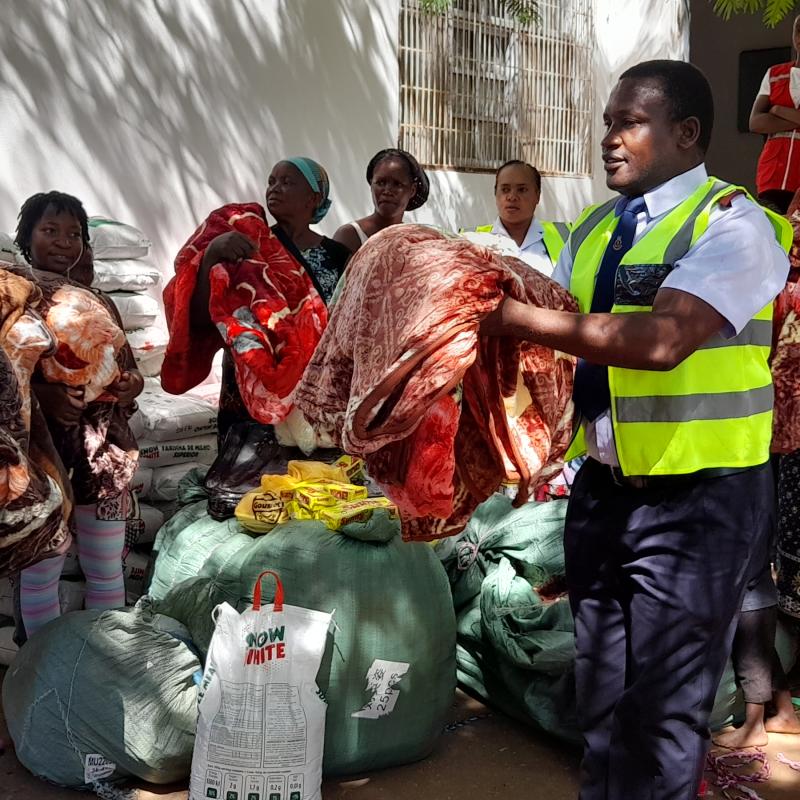 A Salvation Army officer hands out blankets