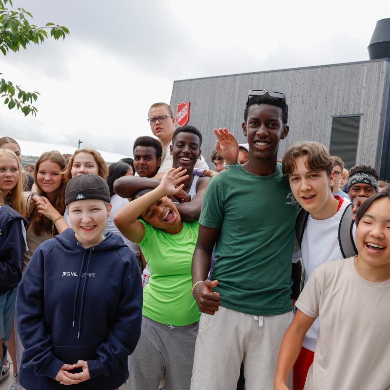 A group of young people outside a Salvation Army building