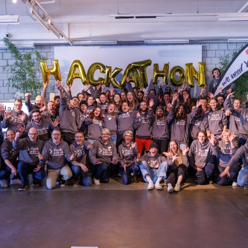 A group of people in Salvation Army hoodies pose for the camera