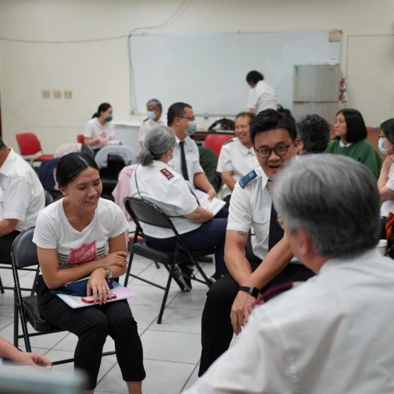 People in Salvation Army uniform talk in a group