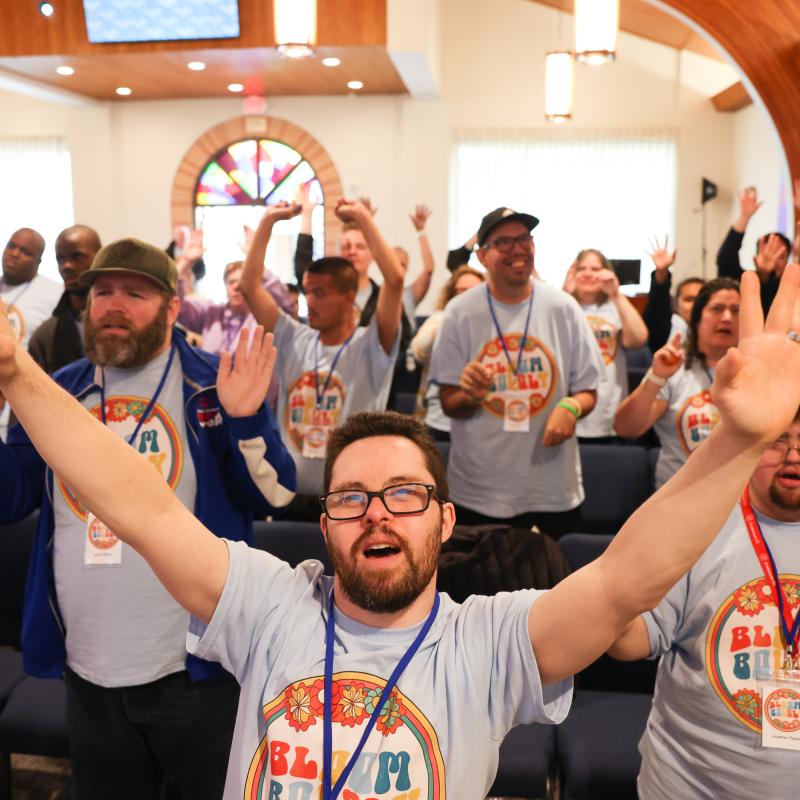 People raise their hands in worship