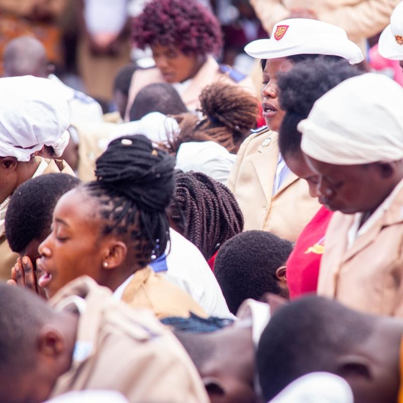 People bow their heads in prayer