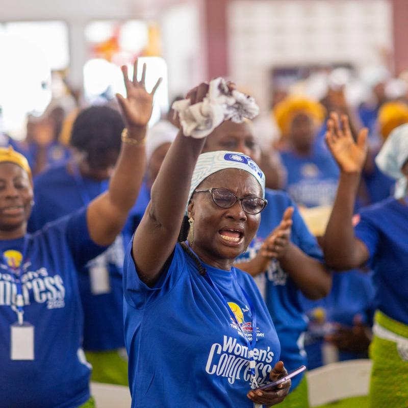 Women raise their hands in worship