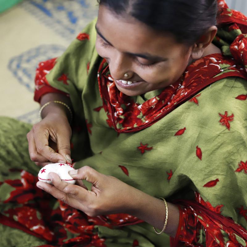 A woman works on hand embroidery