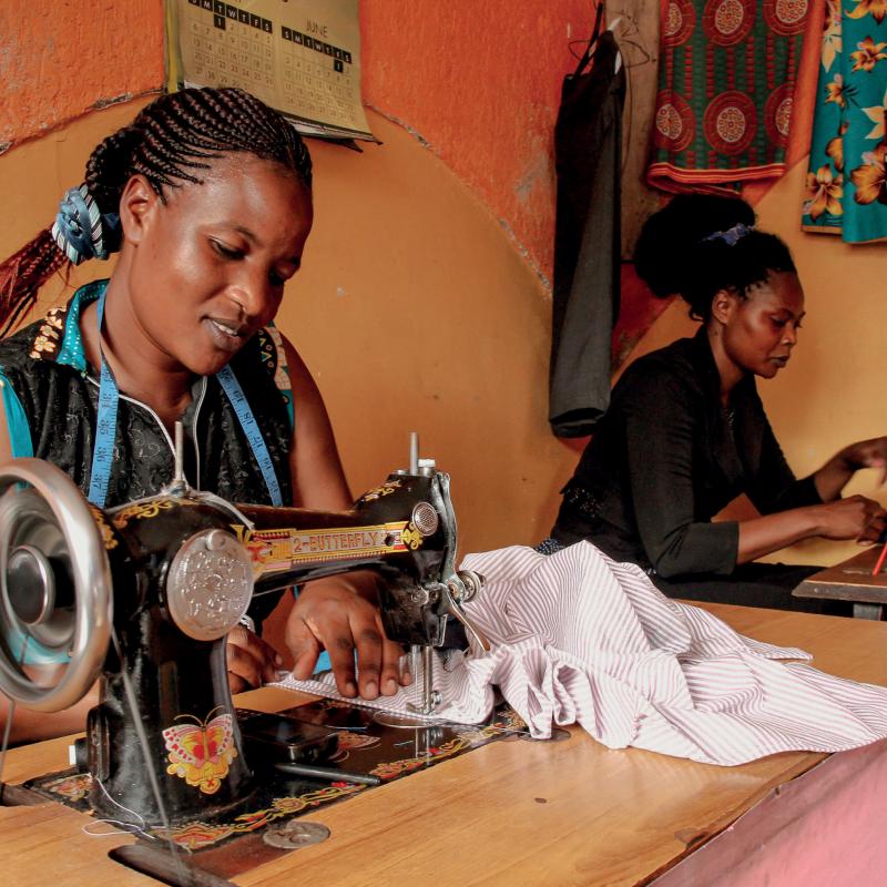 Two women work at sewing machines
