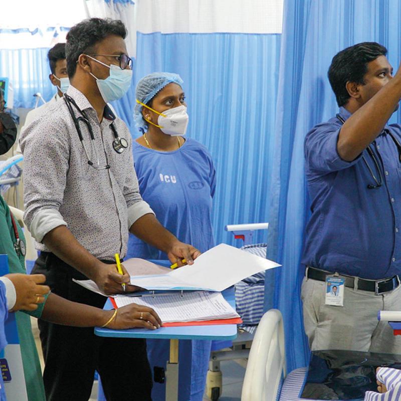 Doctors view test results at a Salvation Army hospital in India