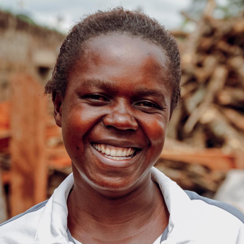 A woman smiles at the camera