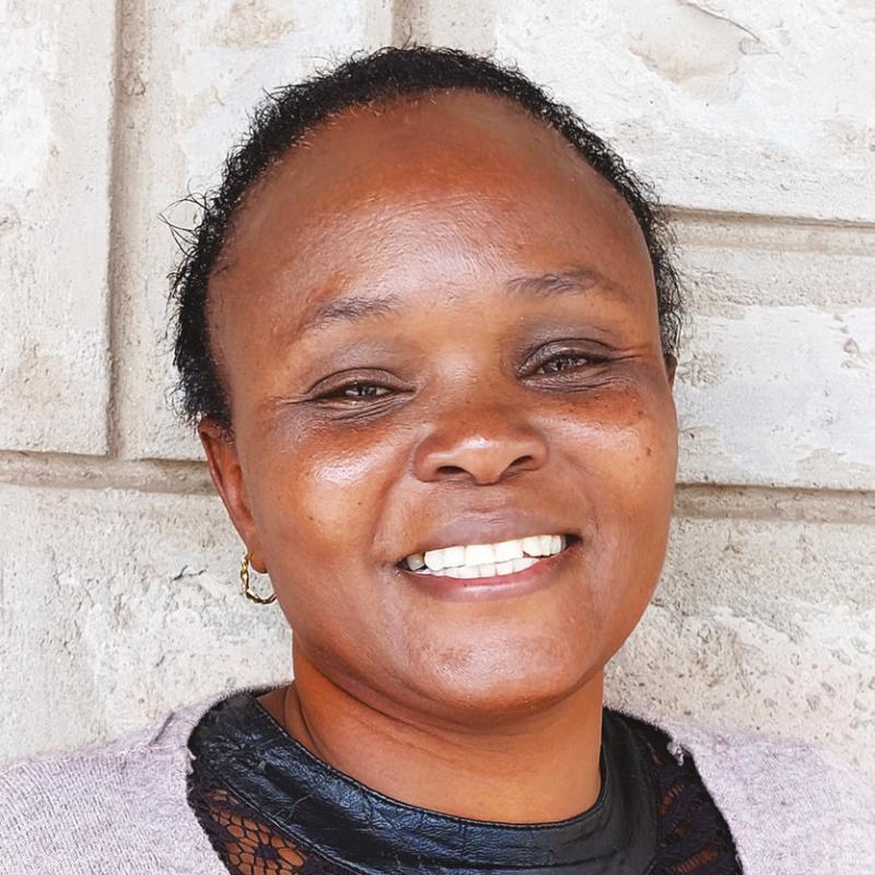 A woman smiles at the camera
