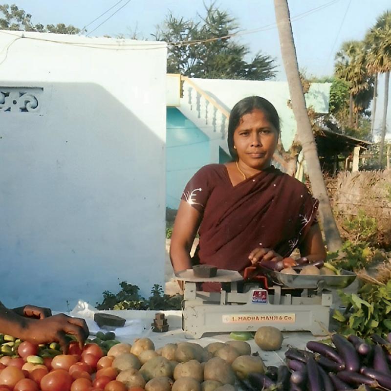 A woman runs a vegetable stall