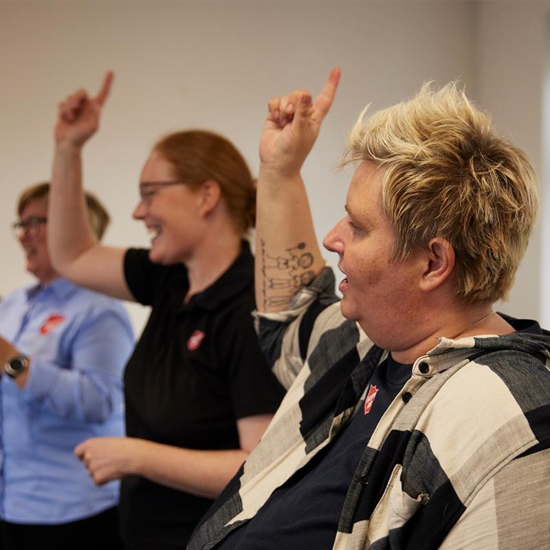 A group raise their hands in worship