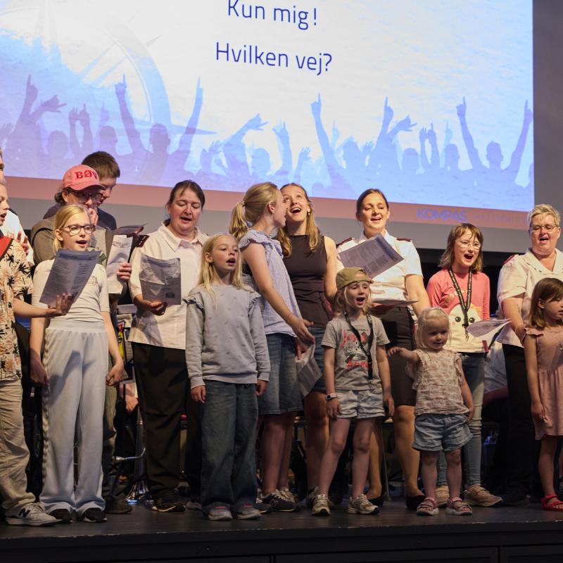 Adults and children sing in a family choir