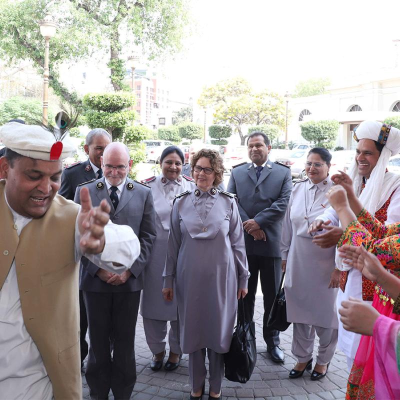 People in traditional dress dance as the international leaders are welcomed to Pakistan