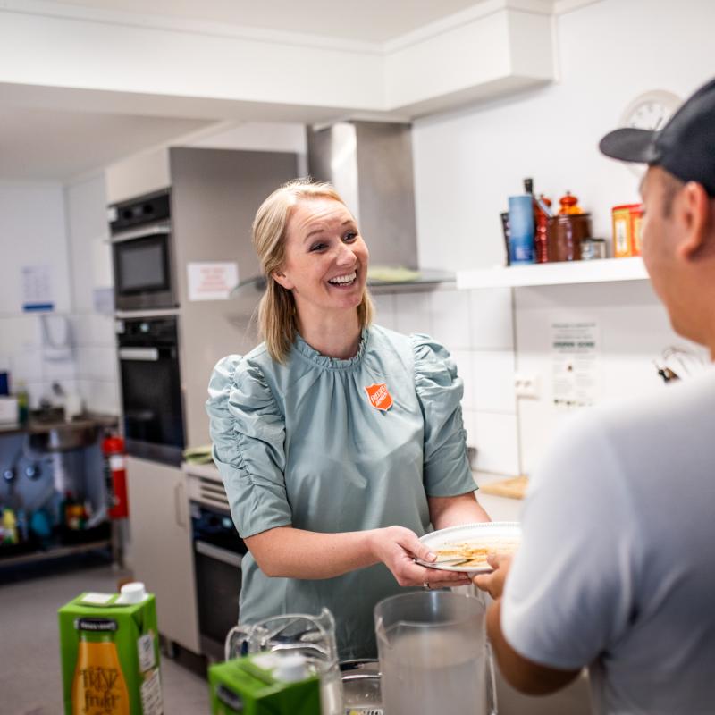 A volunteer offers a warm welcome