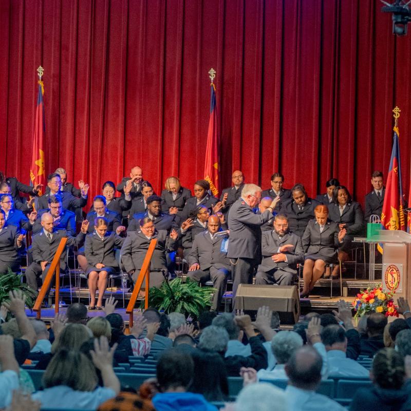 USA Southern Territorial Secretaries along with cadets and Bible Conference delegates, pray a blessing over the international leaders