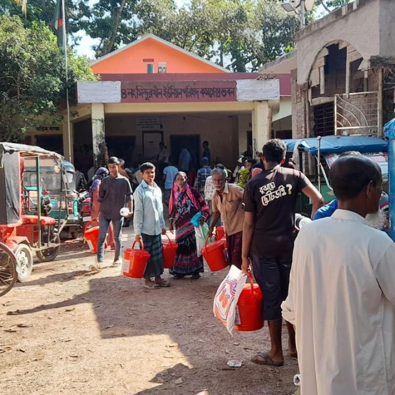 People queue for flood relief supplies