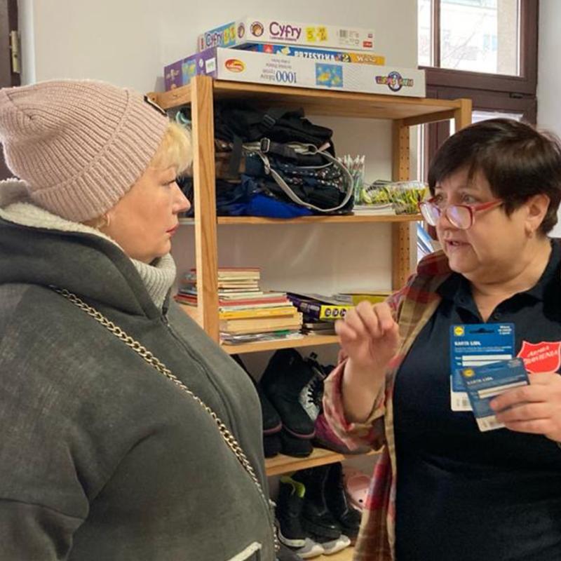 A Salvation Army team member distributing supermarket vouchers