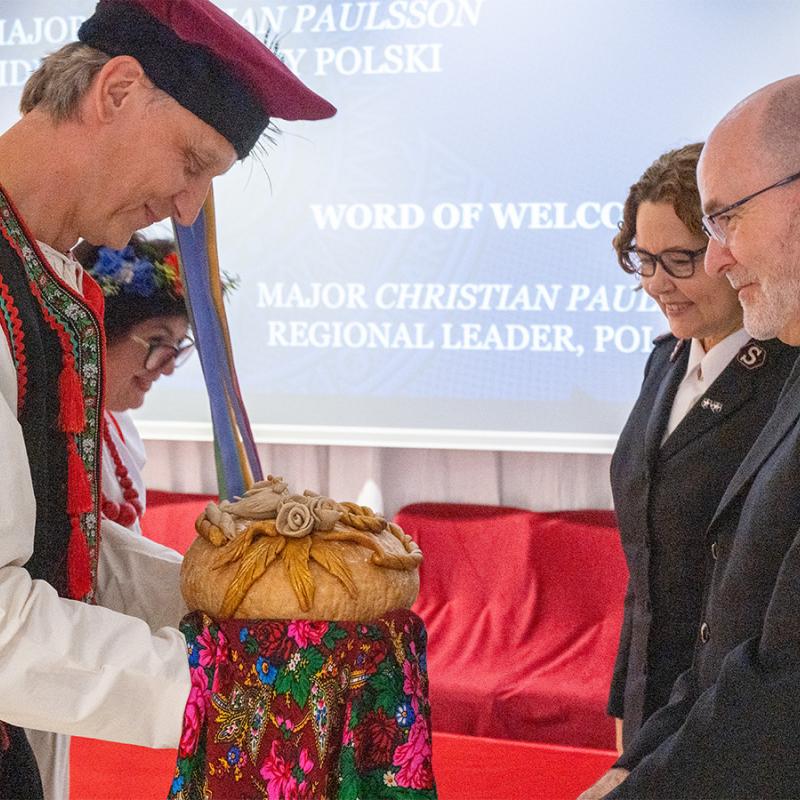 The international leaders are greeted with a traditional welcome gift of bread